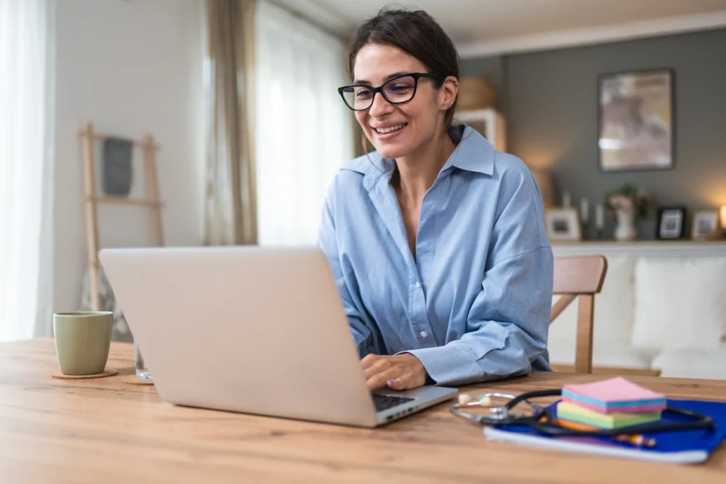 A woman typing on her laptop